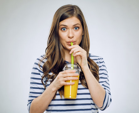 Woman drinking orange juice isolated