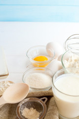 Ingredients for baking cakes on the wooden background. Top view.