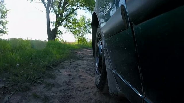 
Car goes on  summer   rural road with grass. POV clip

