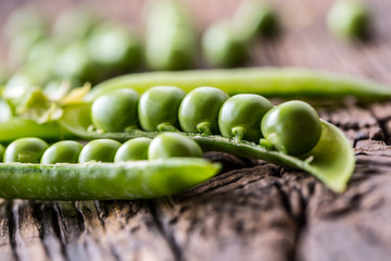 Peas. Fresh bio homemade peas and pods on old oak board. Healthy fresh green vegetable - peas and...
