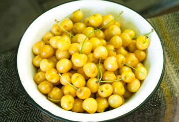 Yellow cherries in a metallic bowl