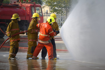 Fireman. Firefighters fighting fire during training.