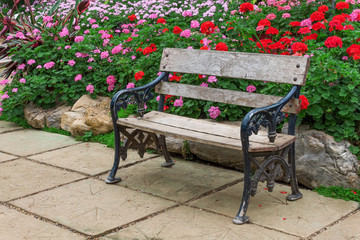 wooden chair in the flowers garden