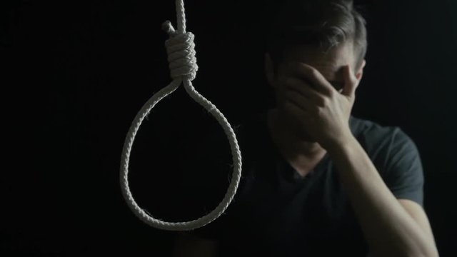 depressed man crying. Guy wants suicide using gallows noose