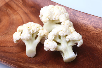 fresh cauliflower on wooden board. Ready for cooking.