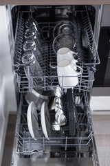 close up of utensils in modern dishwasher