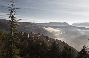 A view of Collepino, little town in Umbria (Italy),with mist and hills around it