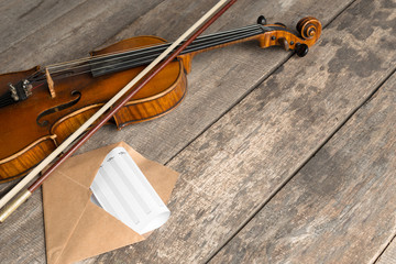 Sheet music and violin on wooden table