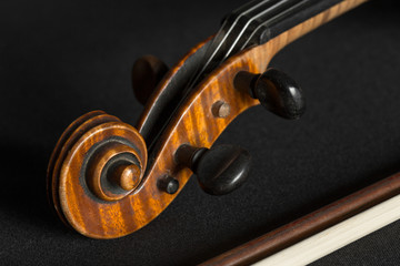 Naklejka na ściany i meble Old violin on a black background