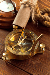 Compass and rope on wooden table. close up