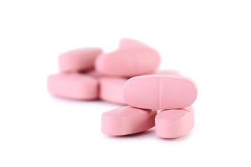 Pink pills isolated on a white background