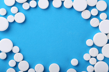 White pills on blue background
