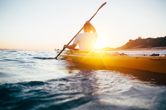 Kayaking at sunset sea
