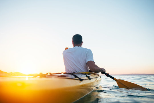 Man paddling the kayak 