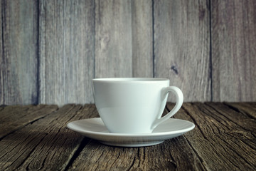 An empty coffee cup on a wooden table