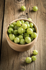 Fresh gooseberry in a wooden bowl.
