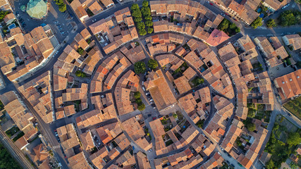 Aerial top view of Bram medieval village architecture and roofs from above, Southern France
