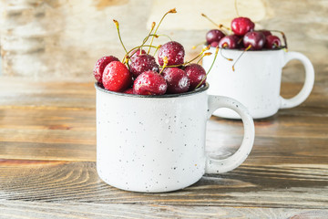 Fresh ripe cherry with a white circle on aged wooden background