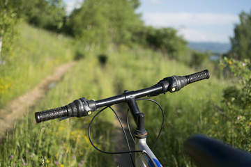 Naklejka na ściany i meble Cross-country mountain bike on off-road track in beautiful nature