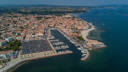 Obraz premium Aerial top view of boats and yachts in marina from above, harbor of Meze town, South France 