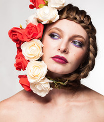 Gorgeous Woman with flowers arround her head in studio photo. Beauty and fashion. Glamour and summer