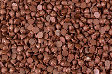 Texture of small chunks of sweetened chocolate chips background