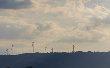 Wind turbine on the mountain at sunset
