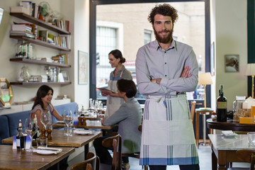 Small business owner smiling in his restaurant