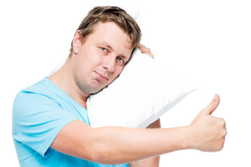 Happy young man with pillow on white background