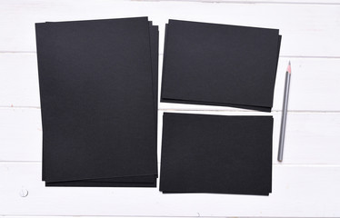 set of stacks of black paper different sizes