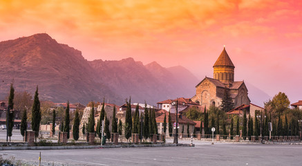 amazing sunset view of Svetitskhoveli Cathedral and mountains in sunset, Mtskheta, Georgia - obrazy, fototapety, plakaty