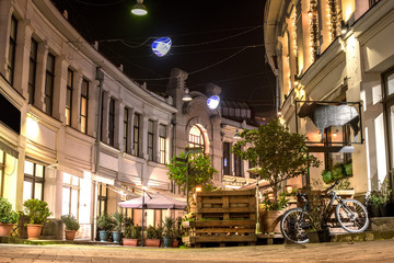 beautiful square with shops and cafes in night town