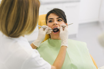 Woman repairing teeth at the dentist office