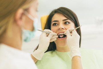 Woman repairing teeth at the dentist office