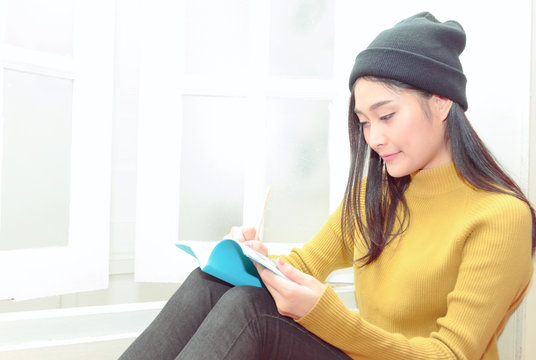 Asain Woman Write Notes Near The Window, Relaxing Lifestyle