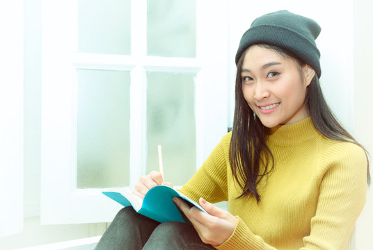 Asain Woman Write Notes Near The Window, Relaxing Lifestyle