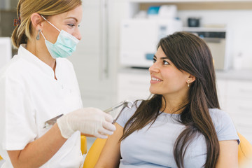 Tooth extraction. Dentist and patient at the dental office.