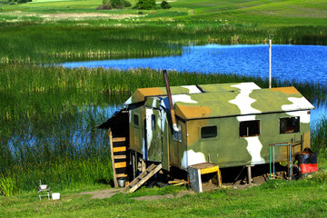 Fototapeta na wymiar A small house on the lake for housing guards and fishermen