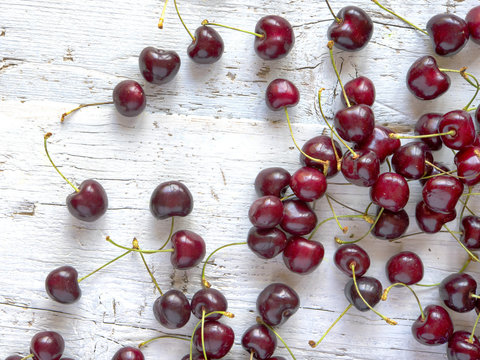 Fresh, Ripe, Juicy Cherries on White wooden table, top view