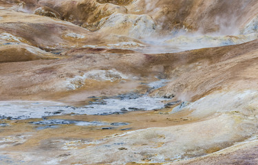 Red Ground ad hot water of Geothermal Landscape Krafla, Iceland