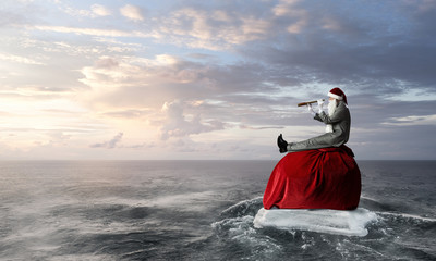 Naklejka premium Santa looking for the way. Mixed media