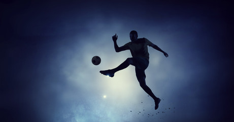 Fototapeta na wymiar Soccer player with ball outdoors