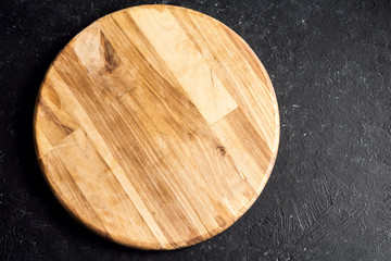 round cutting board on black background