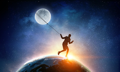 Obraz na płótnie Canvas Woman catching moon