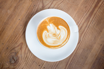 Coffee latte art on wood table