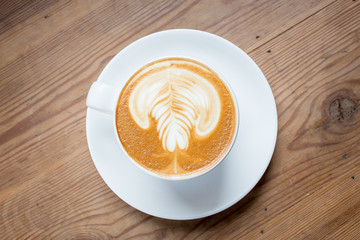 Coffee latte art on wood table