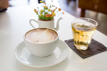 Cup of coffee on a table with flowers