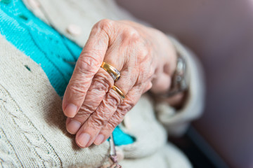 Hand of elderly woman with rings