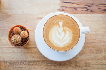 Cup of coffee on a table with flowers