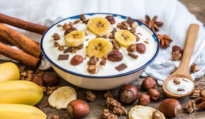 Fototapeta premium Serving of White Yogurt with Muesli, Banana and Nuts
